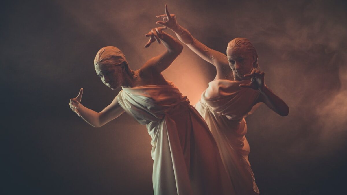 man in white shirt and woman in white dress dancing