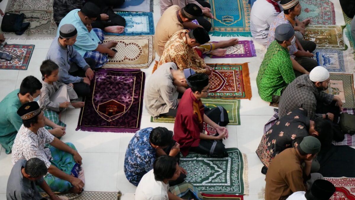 a group of people sitting on top of rugs