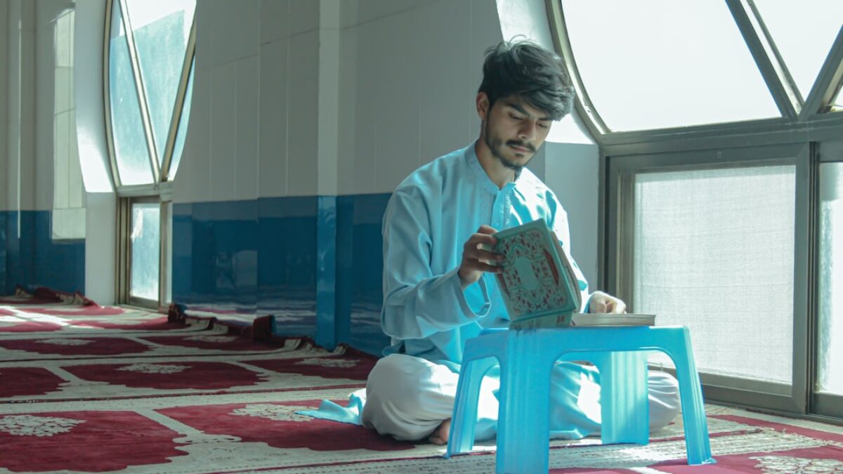 a person sitting on the floor reading a book