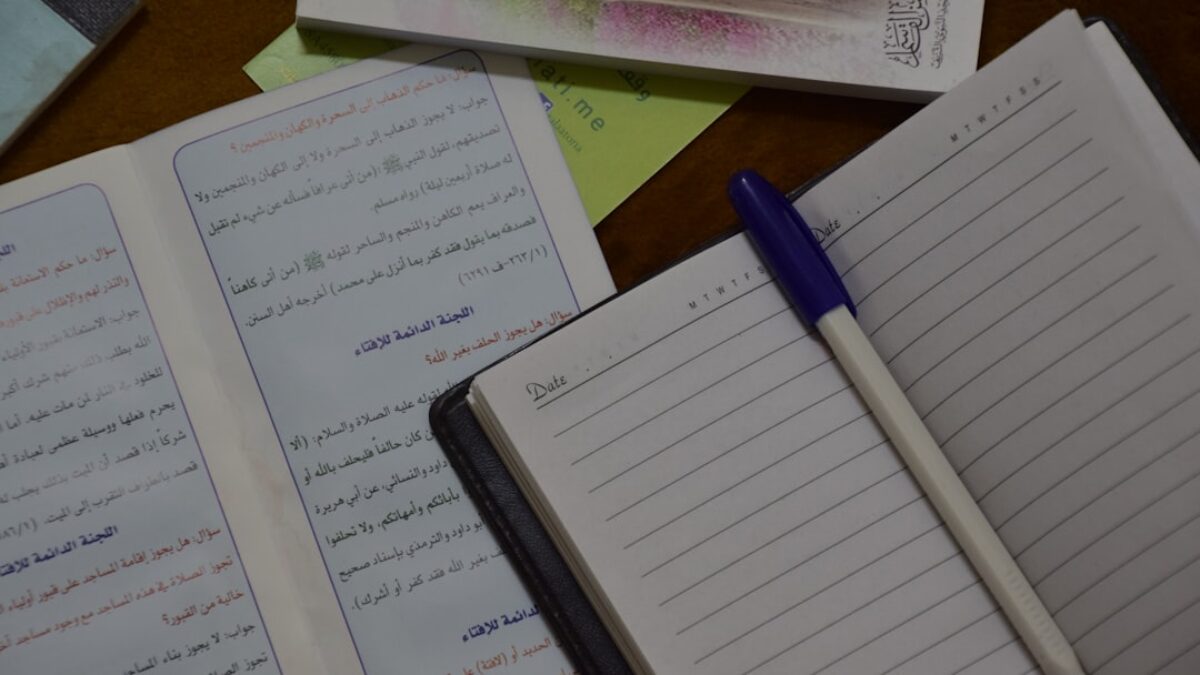 blue pen on white ruled paper