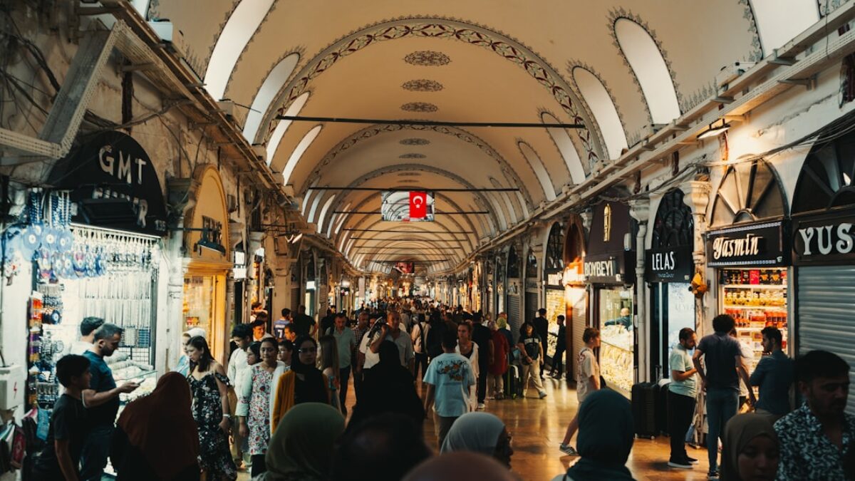 a crowd of people walking through a train station
